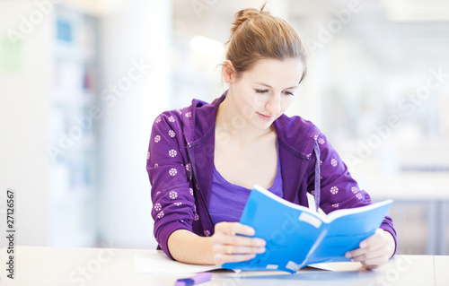 pretty young college student in a library  shallow DOF  color to