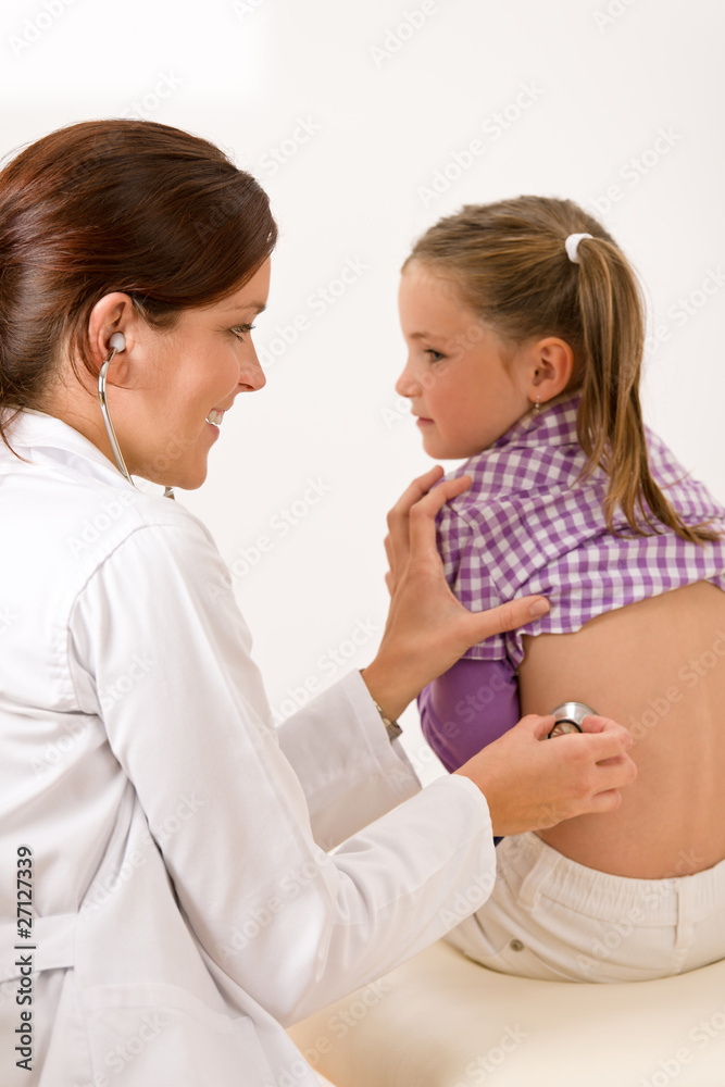 Female doctor examining child with stethoscope Female doctor examining child with stethoscope