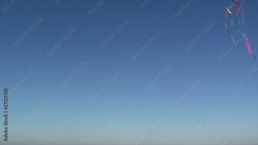 Flying kite against a vivid blue sky