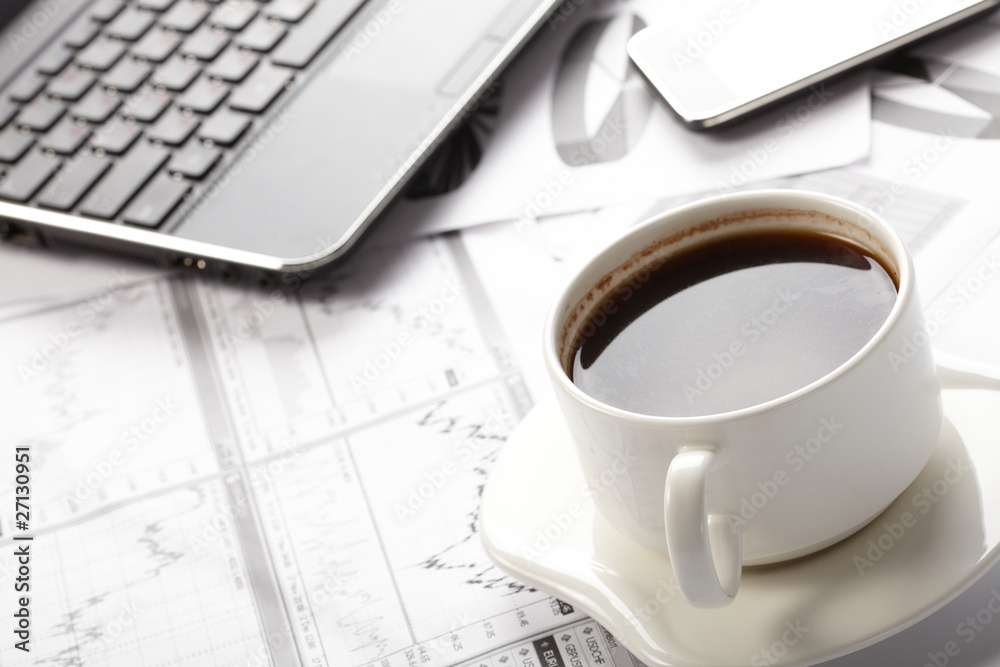 Cup of fragrant coffee on a morning paper business news Cup of fragrant coffee on a morning paper business news
