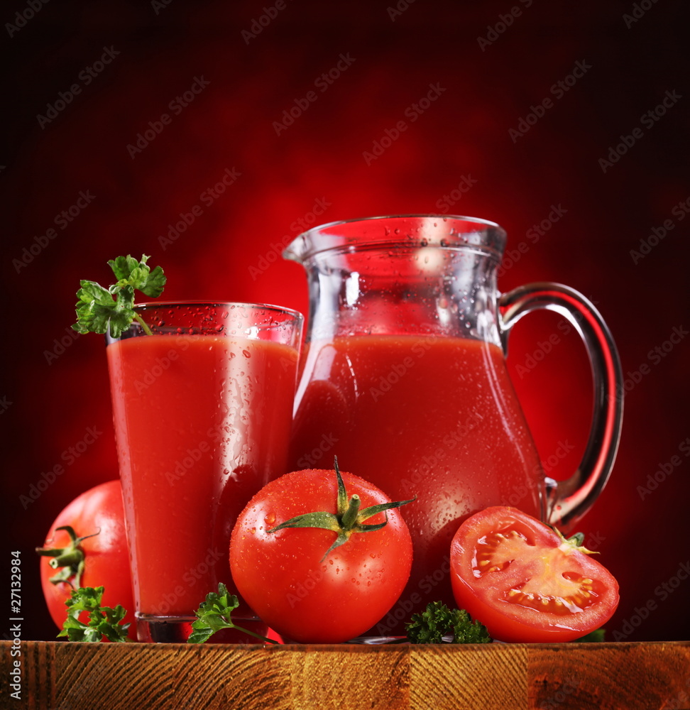 Jug and glass full of tomato juice. Jug and glass full of tomato juice.