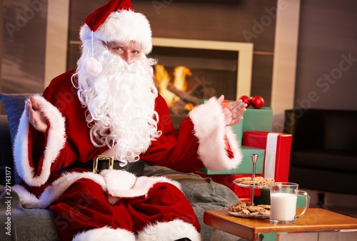 Happy Santa with milk and chocolate chip cookies photo