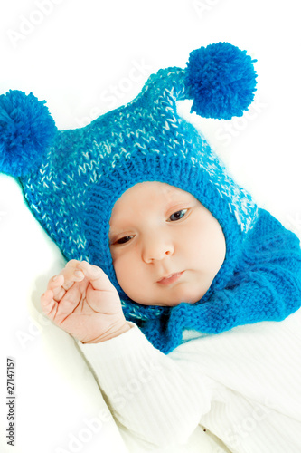 little baby boy in blue hat over white