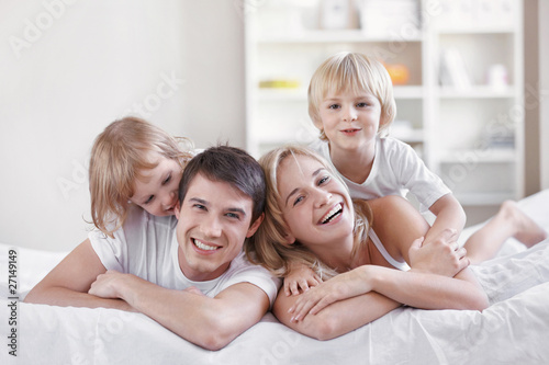 Smiling parents with children at home