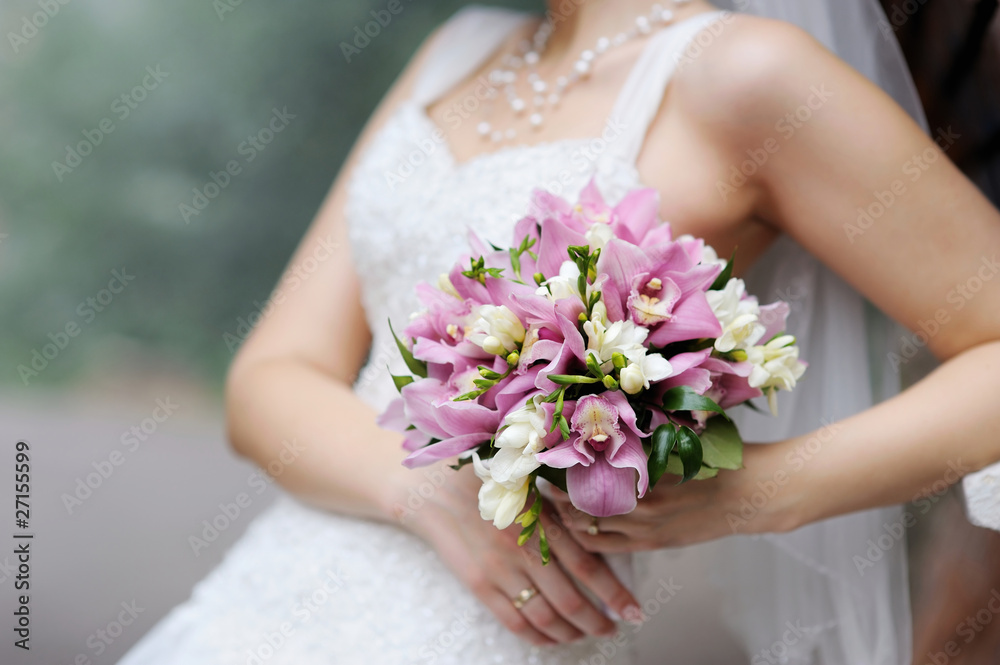 Bride holding pink wedding flowers bouquet Bride holding pink wedding flowers bouquet