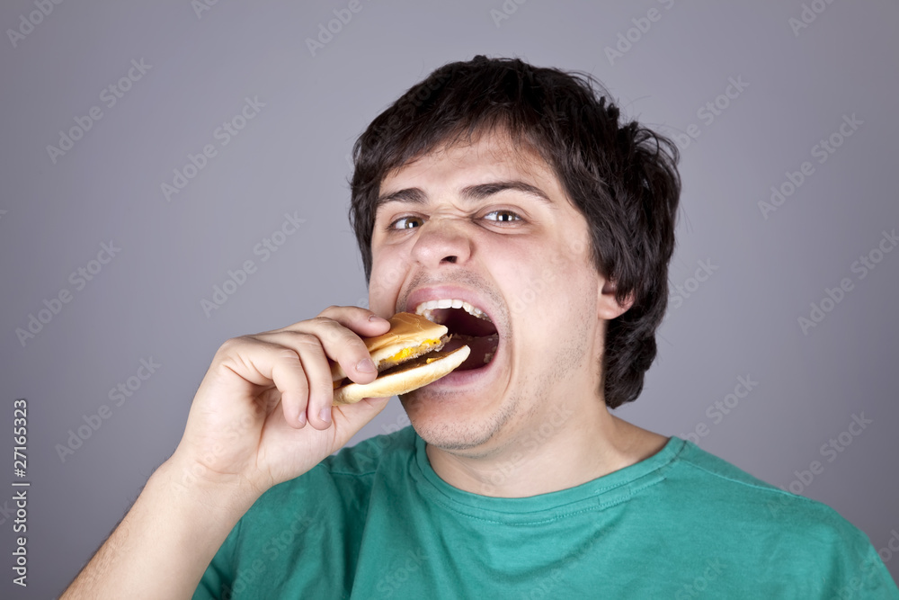 Cute boy eating hamburger.