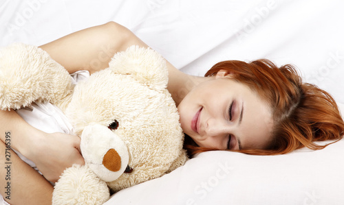 Quadro em tela Woman in white nightie lying in the bed with soft toy.