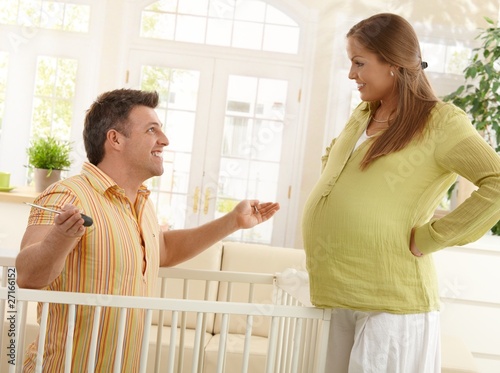 Laughing parents expecting baby