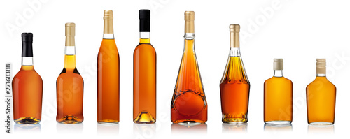 Set of brandy bottles isolated on white background photo