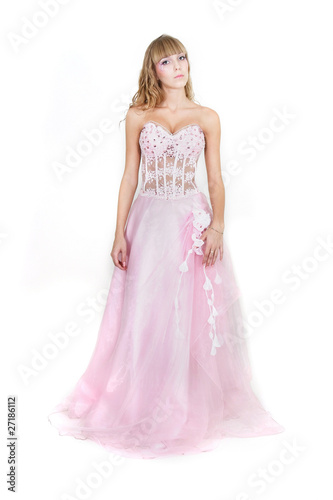 studio shot of young attractive woman in pink wedding dress over