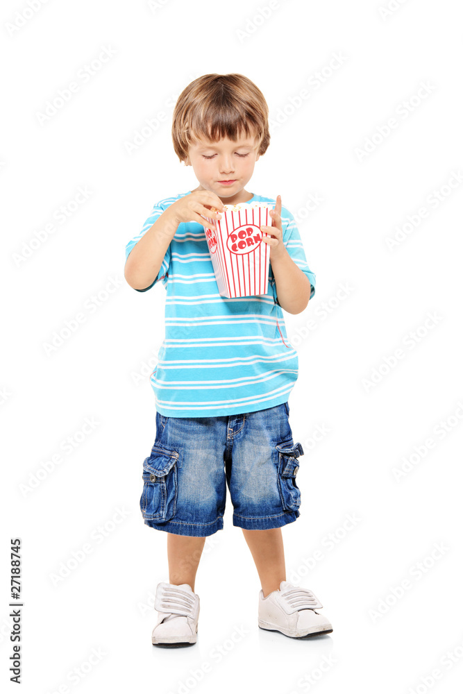 Full length portrait of a young boy eating popcorn Full length portrait of a young boy eating popcorn