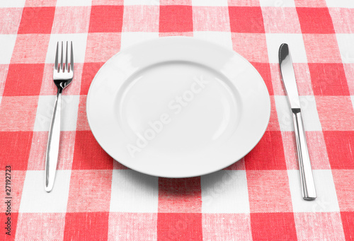 Knife, white plate and fork...