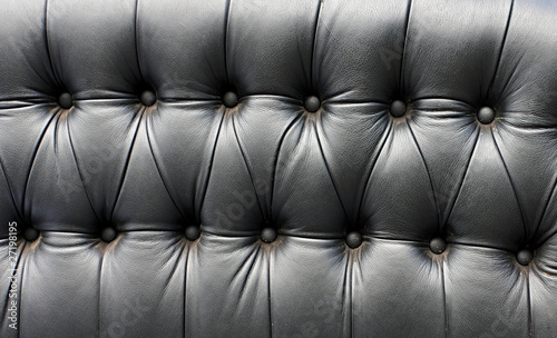 Black leather seat in an old car (close-up)