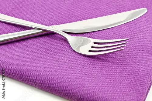 knife and fork on textile napkin