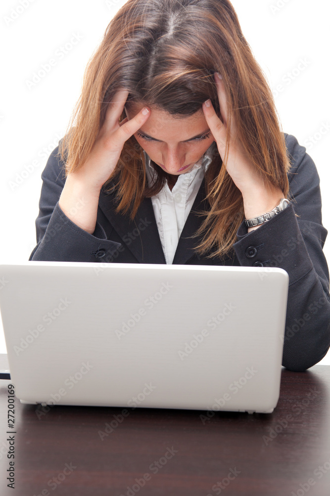 Businesswoman having a headache in front of her notebook Businesswoman having a headache in front of her notebook