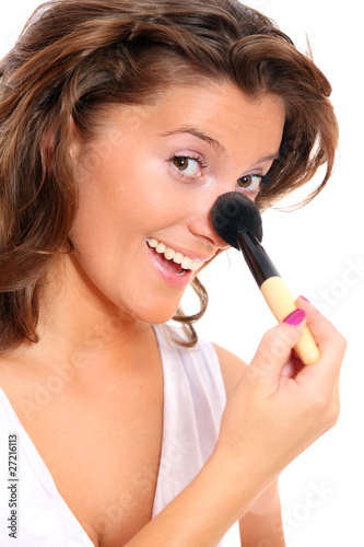 Cute woman putting on her makeup