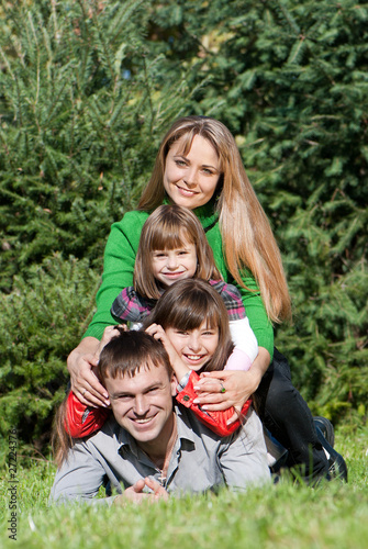 Happy parents and daughters in park