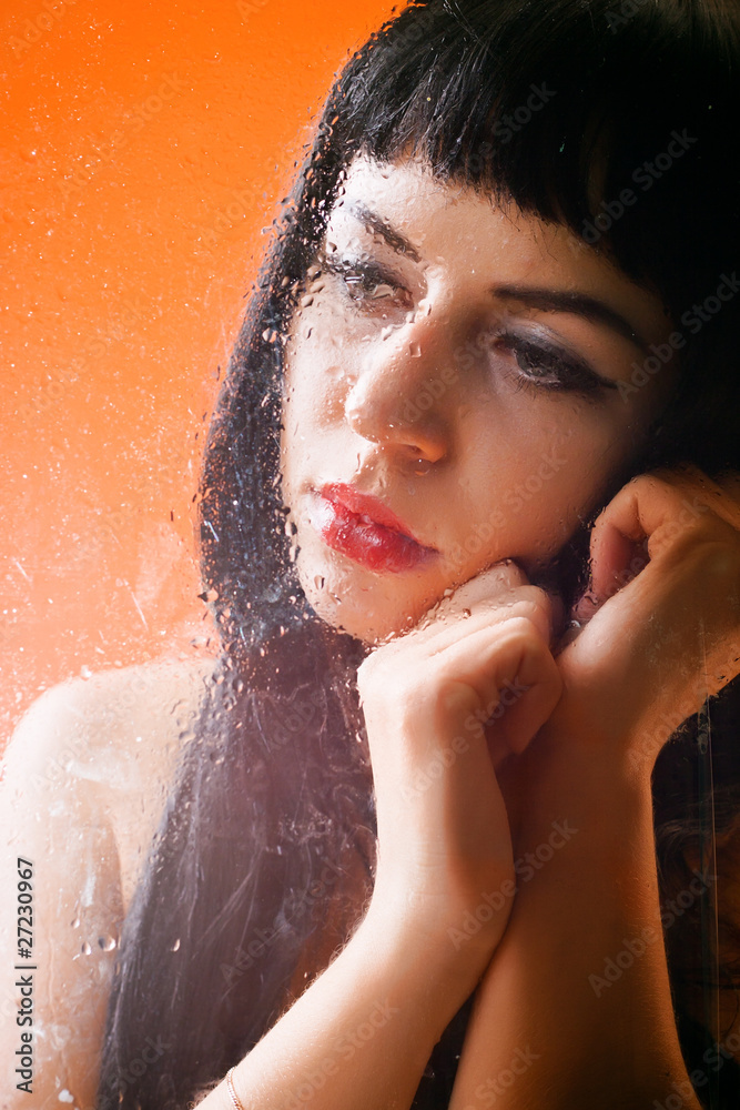Naklejka premium Woman behind glass