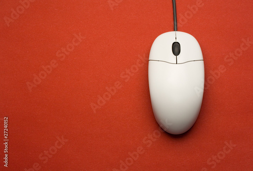 Computer mouse isolated on the red background