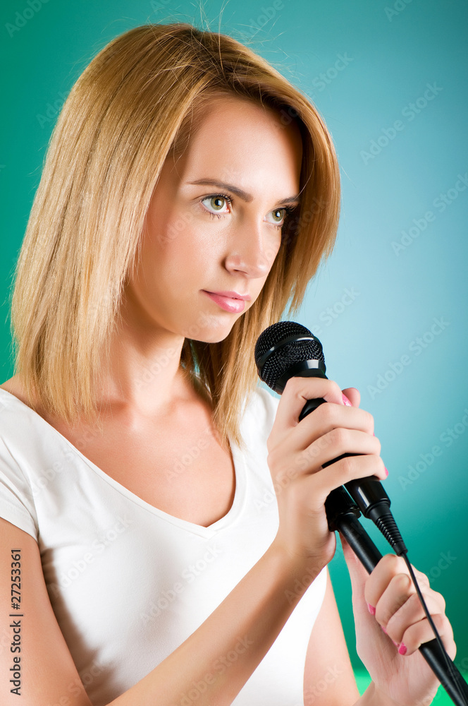 Girl singing with microphone against gradient background Girl singing with microphone against gradient background