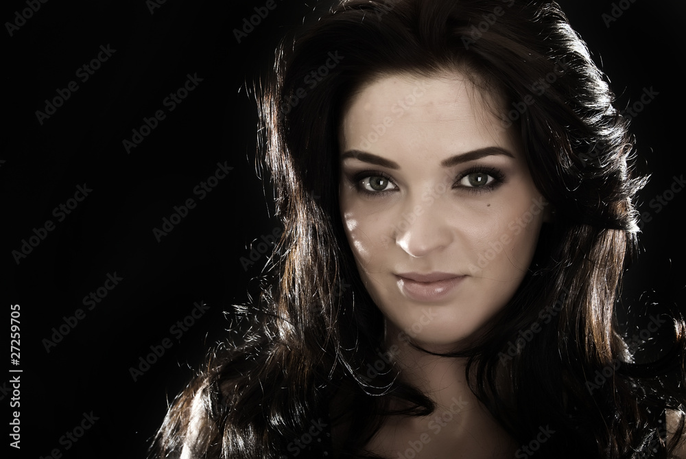 Portrait of a young brunette over black Portrait of a young brunette over black