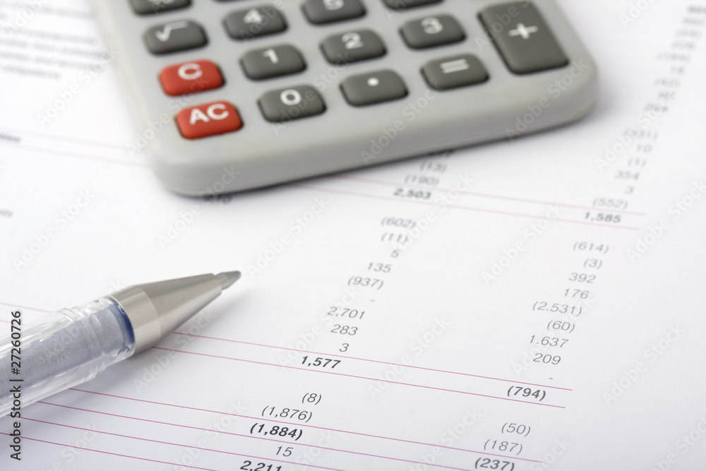 Business financial reports with pen and calculator Business financial reports with pen and calculator