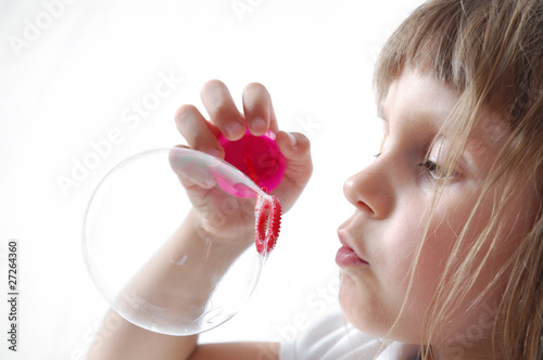 child blowing bubbles