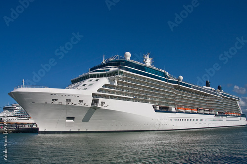 Fototapeta Naklejka Na Ścianę i Meble -  Luxury Cruise Ship Docked Under Blue Sky