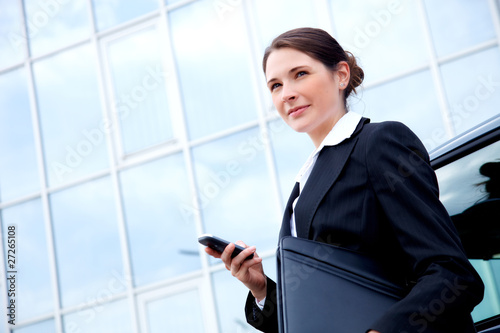 Young business lady outside with mobile phone photo