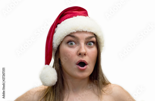 Surprised young women in a Santa Claus hat.
