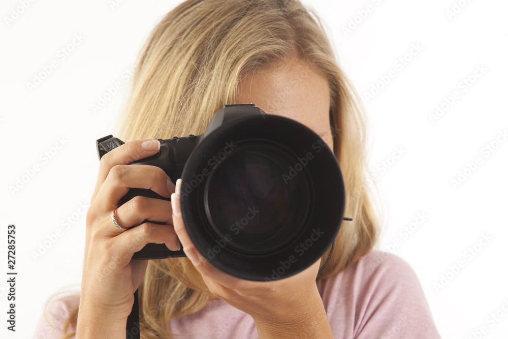 Young woman with camera taking a picture Young woman with camera taking a picture