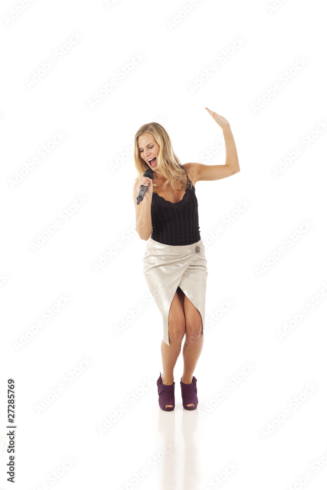 Young woman with microphone dancing and singing Young woman with microphone dancing and singing