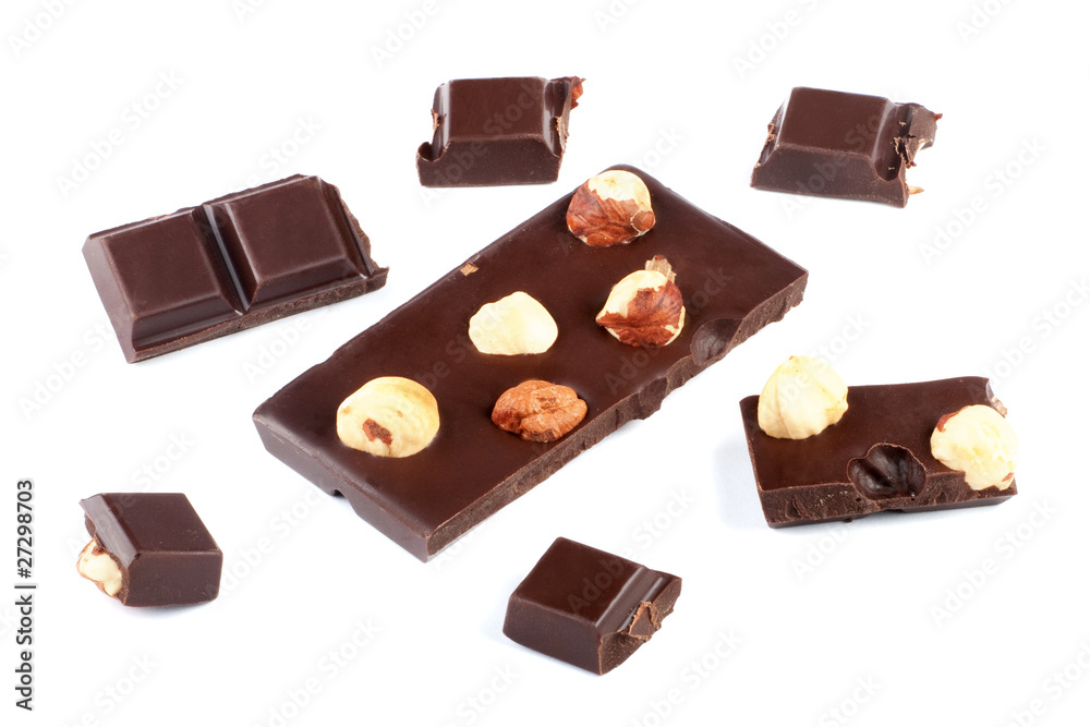 Pieces of milk chocolate bar with nuts isolated on white Pieces of milk chocolate bar with nuts isolated on white
