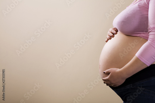 Maternity woman waiting in pink blouse