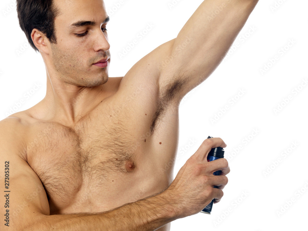 Young Man Applying Deodorant. Model Released Young Man Applying Deodorant. Model Released