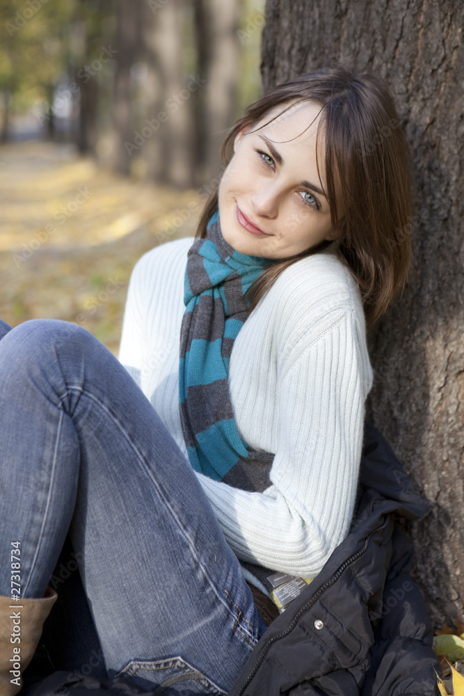 Beautiful romantic brunette with golden autumn leaf Beautiful romantic brunette with golden autumn leaf