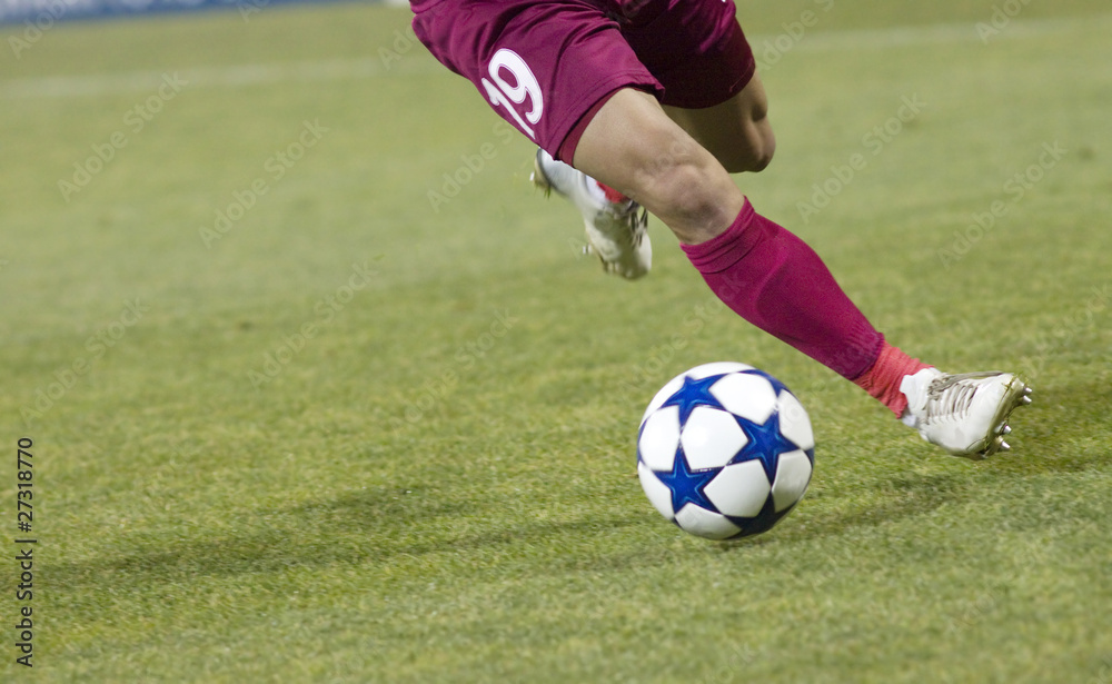 Soccer player running after the ball