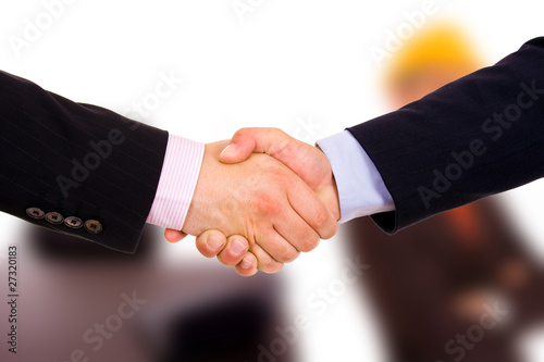 Closeup of business people shaking hands at the office