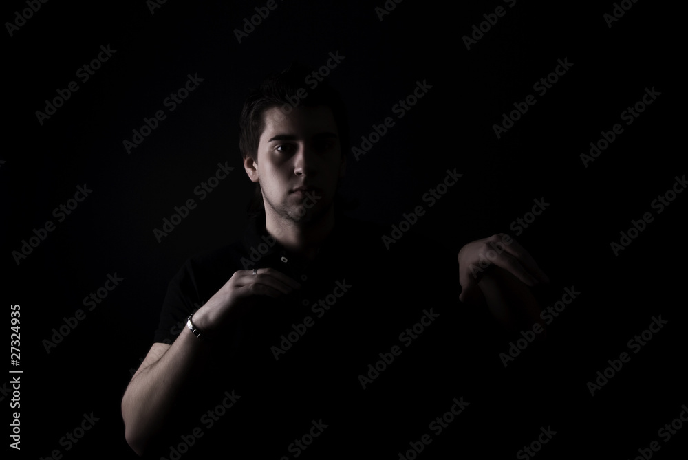 portrait of a young man in darkness portrait of a young man in darkness