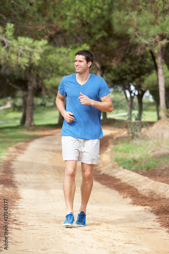 Young man running in park