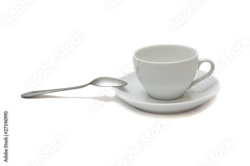 white cup with spoon and saucer isolated on white