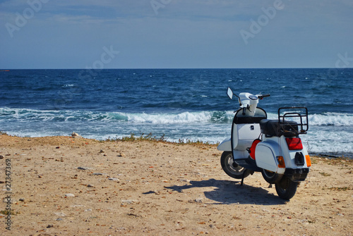 White motor scooter with sea in background © dannywilde