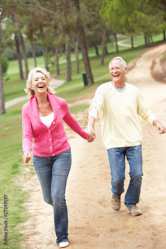 Senior Couple enjoying walk in park © Monkey Business