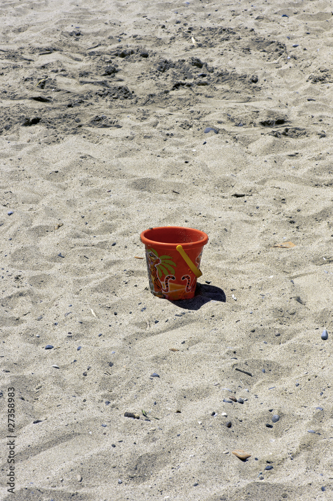 A child beach bucket on the sand A child beach bucket on the sand