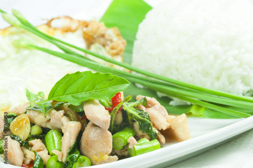 Spicy fried chicken with basil leaves