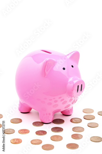 A view of a pink piggy bank and many coins