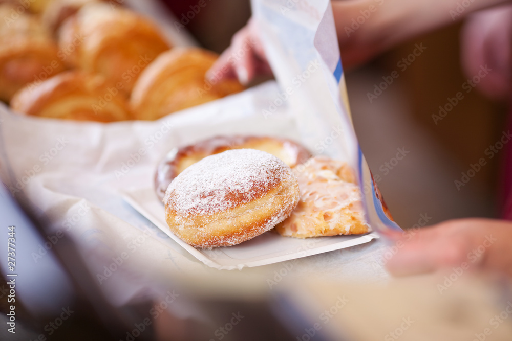 verkäuferin packt süße teilchen ein verkäuferin packt süße teilchen ein