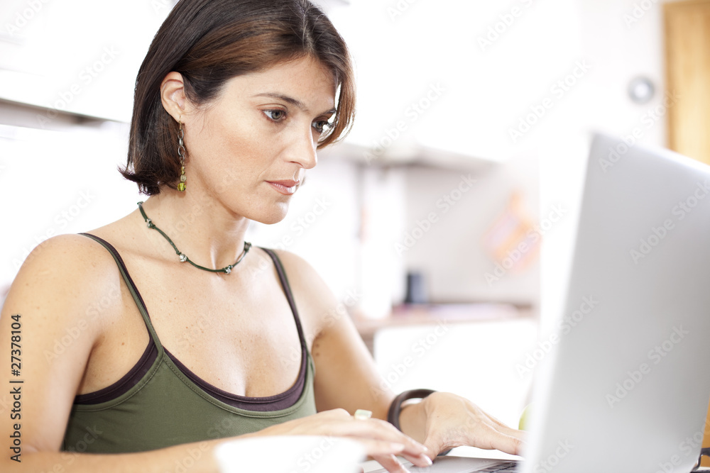 Modern woman reading e-mails at her breakfast Modern woman reading e-mails at her breakfast