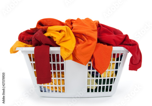 Colorful clothes in laundry basket. Red, orange, yellow.