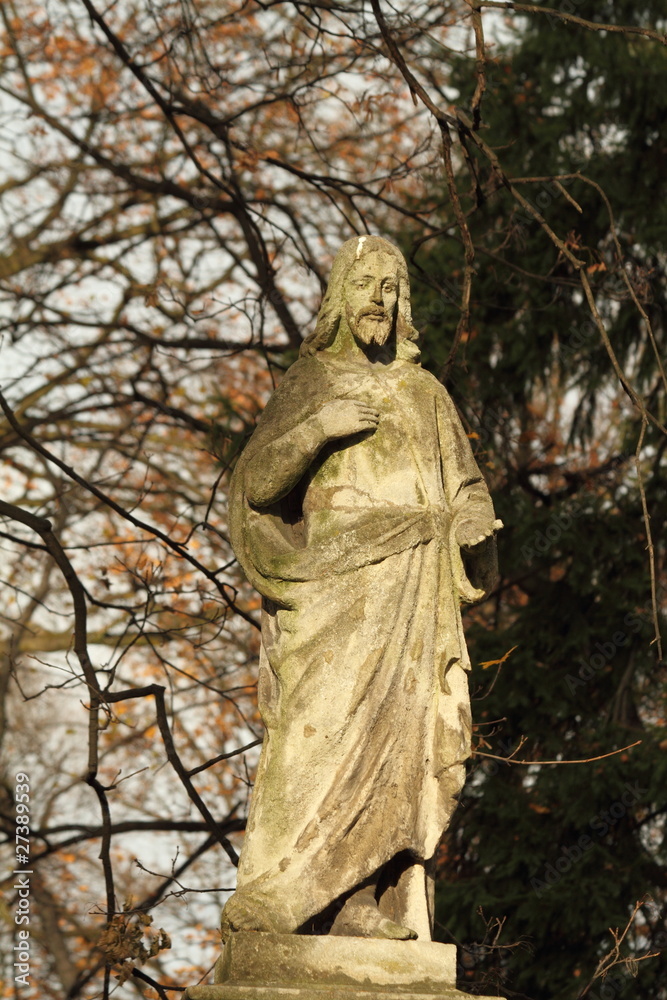 figure of Jesus in sunlight on ancient cemetery figure of Jesus in sunlight on ancient cemetery
